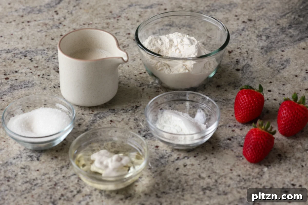 Vegan Strawberry Mousse Cake Gluten Free 7 Various cake ingredients, including flour, sugar, milk, and oil, arranged in bowls on a kitchen counter