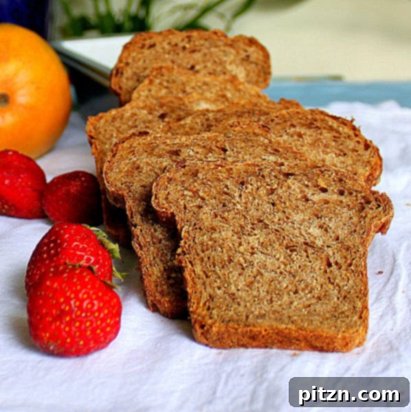 Strawberry Mango Molasses Mini Loaf 3 Slices of a freshly baked Strawberry Mango Molasses Loaf with fresh fruit in the background.