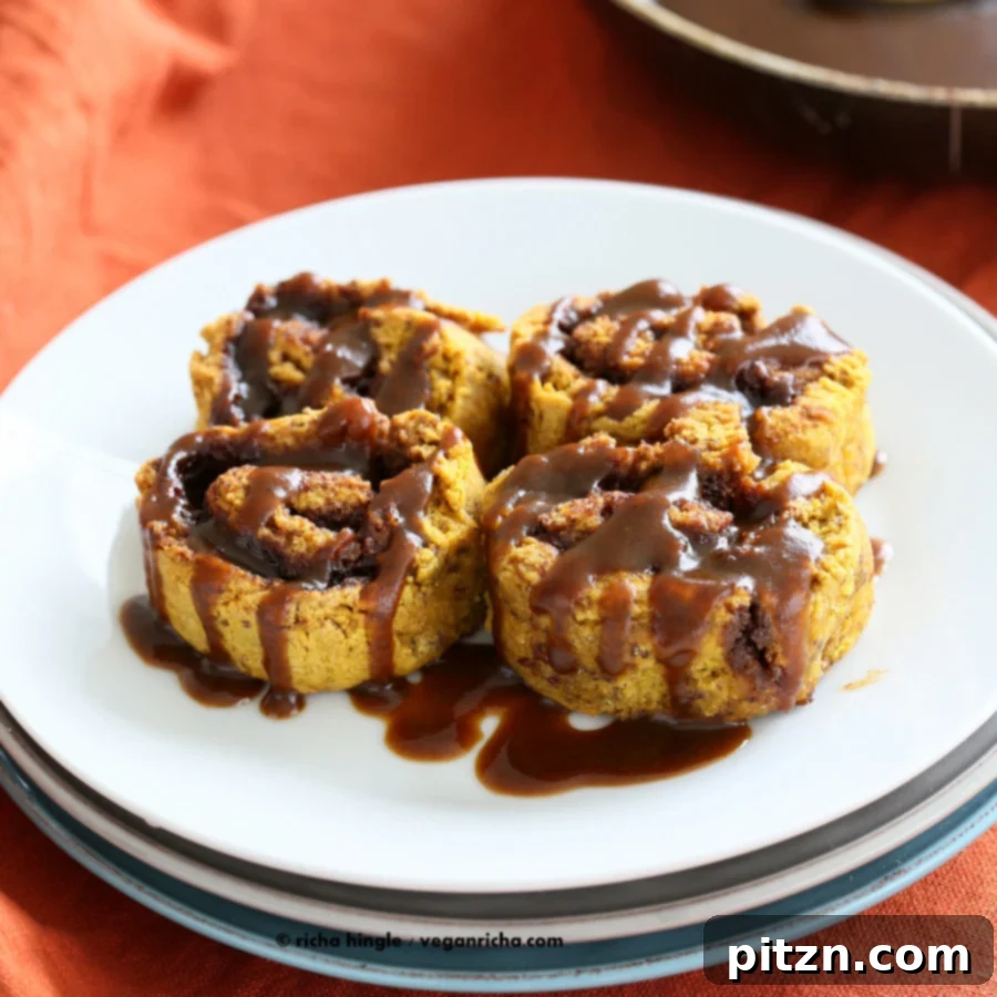 A final shot of gluten-free pumpkin cinnamon rolls with caramel drizzle, ready to be enjoyed.