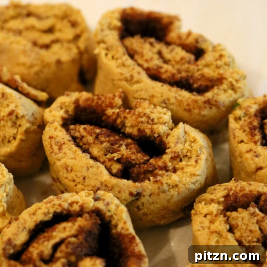 Cozy Gluten Free Yeast Free Pumpkin Cinnamon Rolls 5 Gluten-free pumpkin cinnamon rolls arranged in a baking pan, ready for the oven.