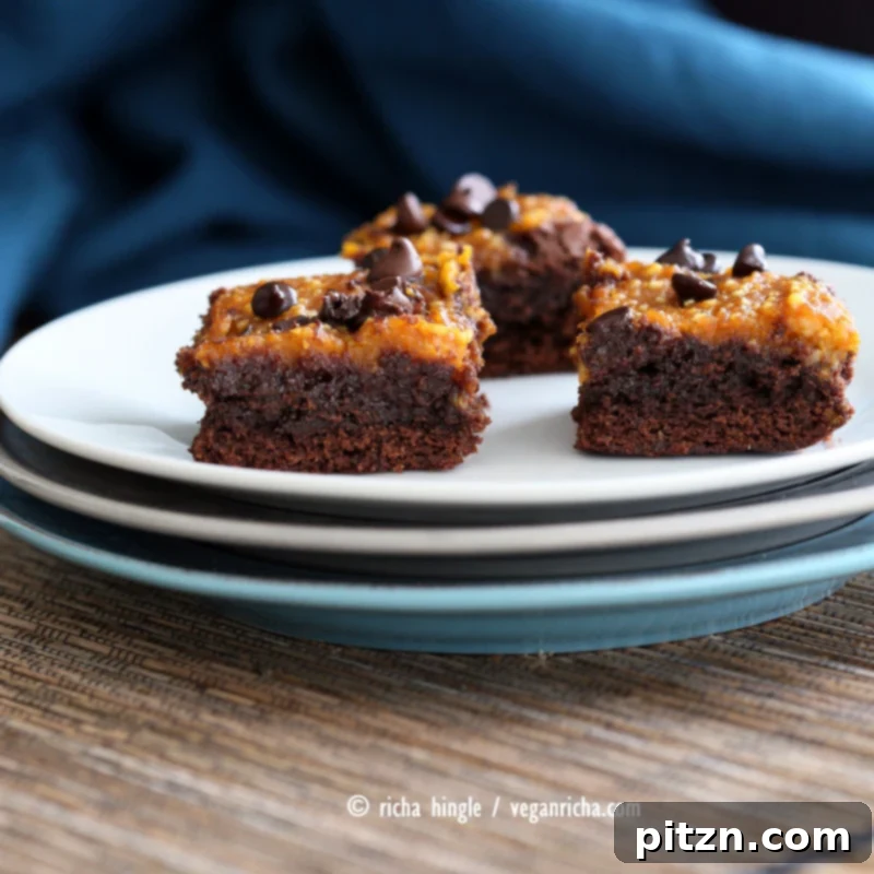 Vegan Pumpkin Pie Brownies 3 Close-up of freshly baked Vegan Pumpkin Brownies, showcasing the creamy pumpkin layer over a rich, fudgy dark chocolate brownie. The ultimate Pumpkin Pie + Brownie dessert. | Vegan Richa