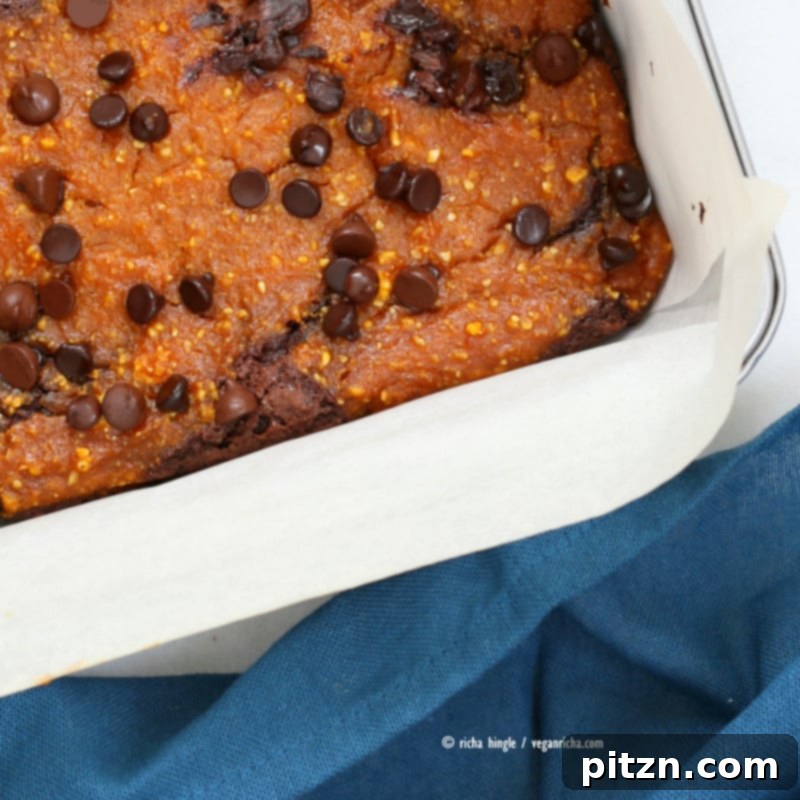 Vegan Pumpkin Pie Brownies 4 A vibrant close-up of Vegan Pumpkin Brownies, highlighting the distinct layers of creamy pumpkin and rich dark chocolate brownie. | Vegan Richa