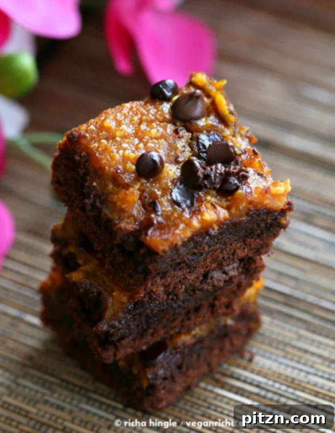Beautifully arranged Vegan Pumpkin Brownies on a rustic wooden surface, perfect for fall celebrations. | Vegan Richa
