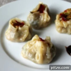 Shu Mai dumplings served on a white plate with beet slices