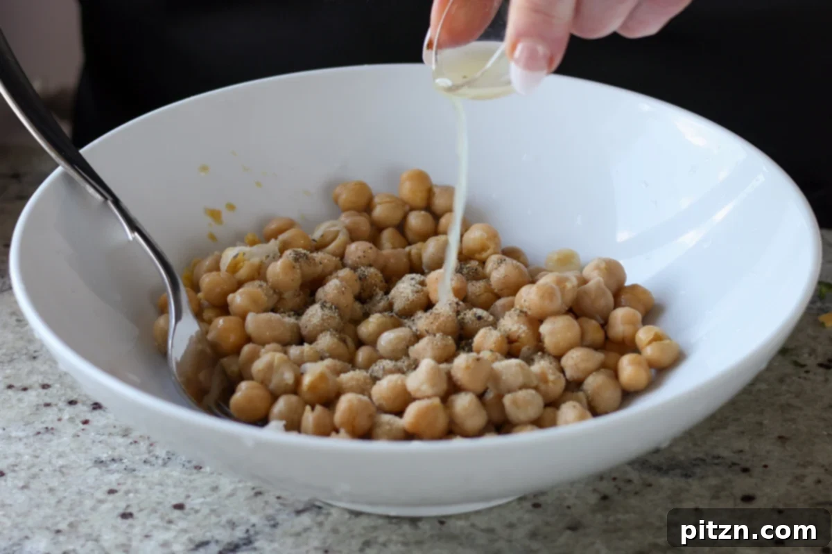 Gochujang Chickpea Sandwich with Sweet and Spicy Caramelized Onions 13 adding lime juice to the chickpeas