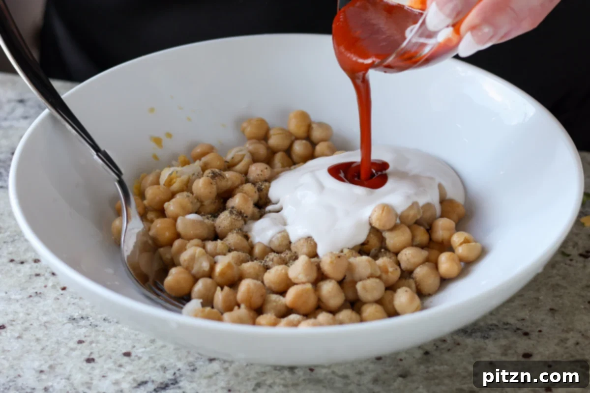 Gochujang Chickpea Sandwich with Sweet and Spicy Caramelized Onions 14 adding vegan mayo and gochujang to the chickpeas