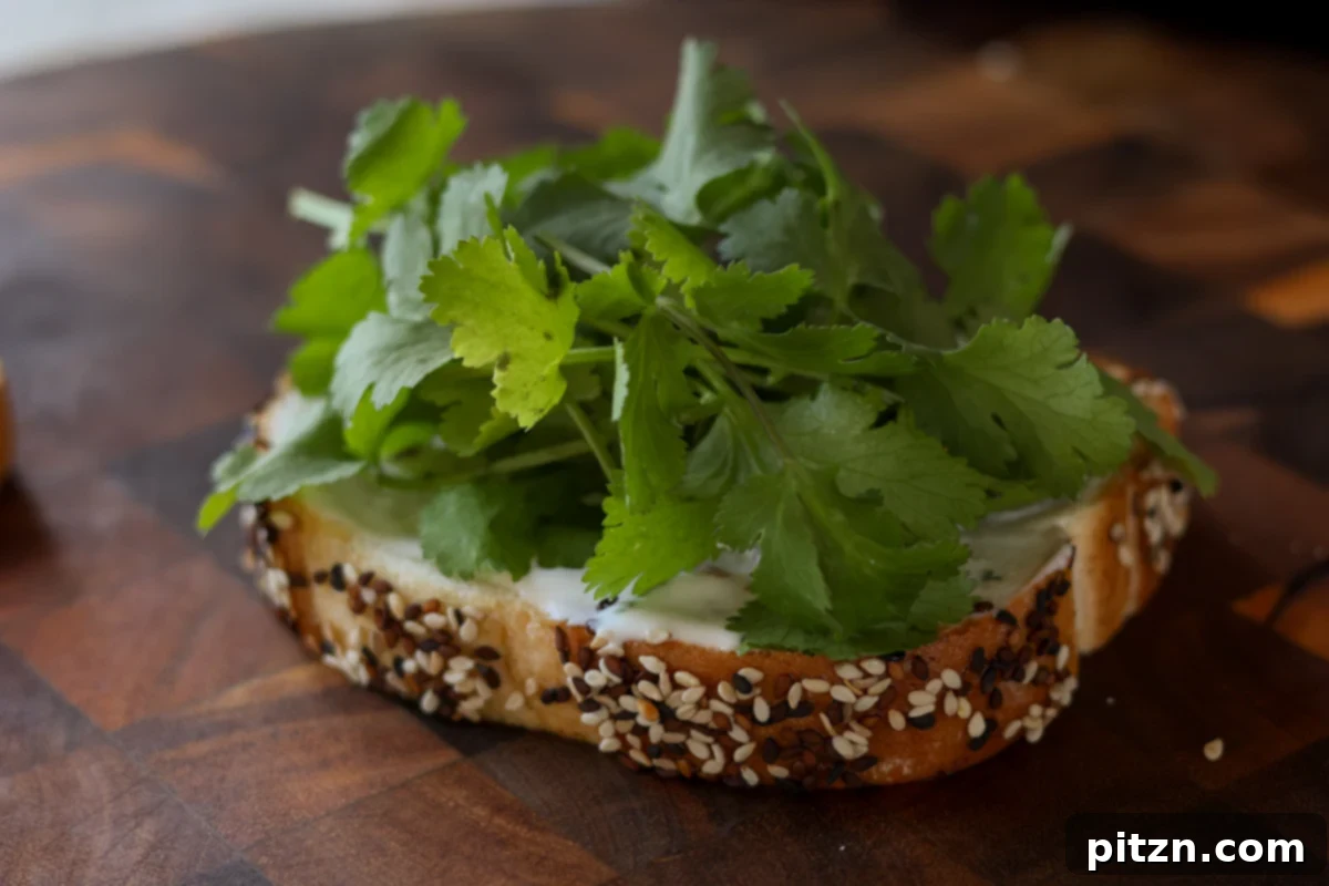 Gochujang Chickpea Sandwich with Sweet and Spicy Caramelized Onions 18 adding cilantro to the bread
