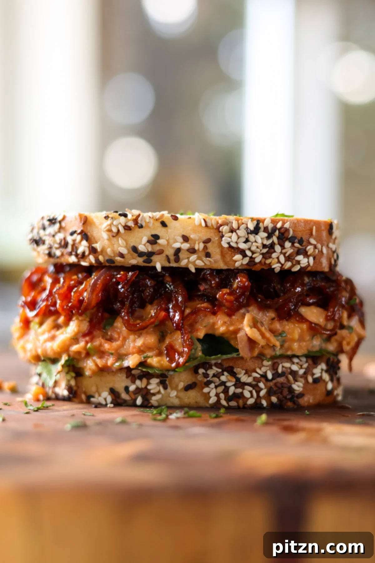 Gochujang Chickpea Sandwich with Sweet and Spicy Caramelized Onions 4 gochujang chickpea salad sandwich on the cutting board before slicing