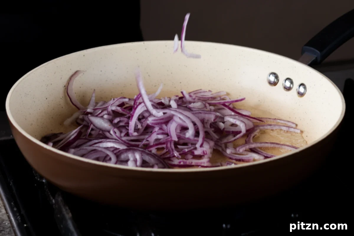 Gochujang Chickpea Sandwich with Sweet and Spicy Caramelized Onions 7 onions in the pan before cooking