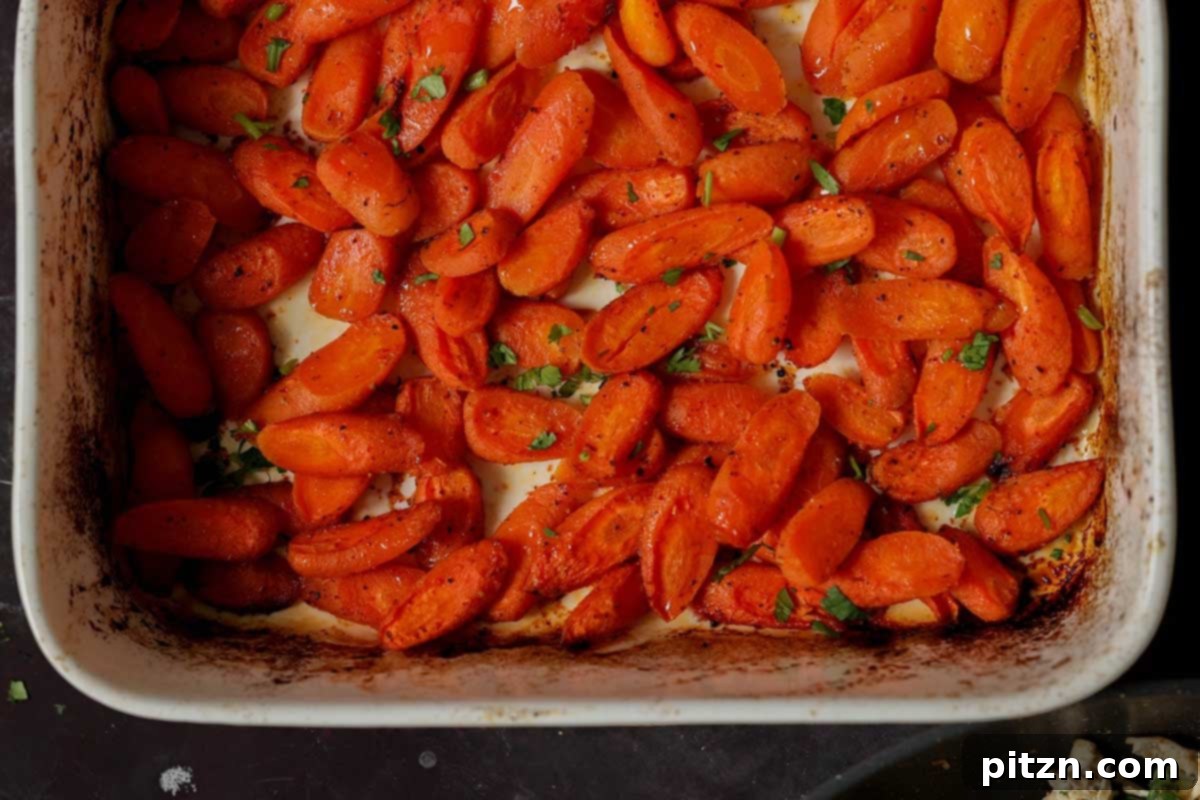 Golden-brown roasted carrots in the pan after baking.
