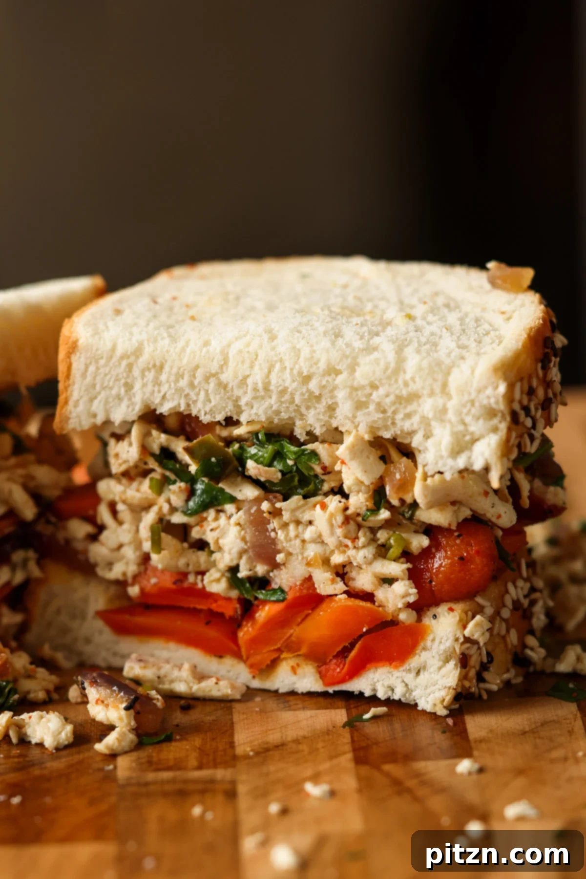 A delicious shredded tofu and roasted carrots sandwich, perfectly sliced and ready to eat.