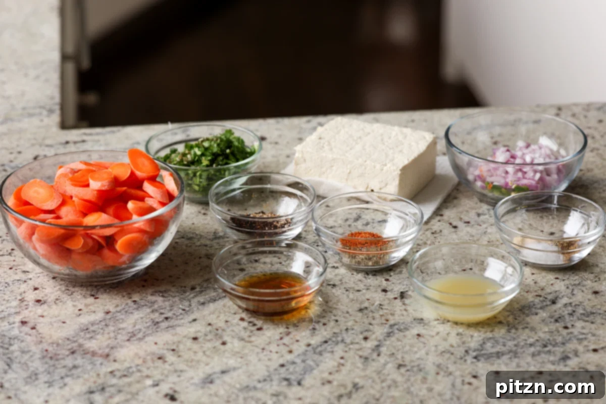 Various ingredients for tofu and carrots, neatly arranged in bowls on a clean kitchen counter, ready for preparation.