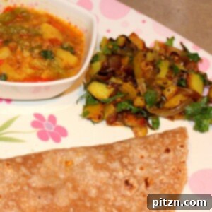 Aloo Pyaaz and Bhaji with Roti/Chapat served on a white and pink plate, featuring vibrant colors of Indian cuisine