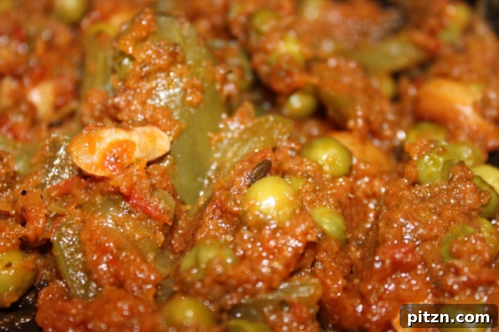 A bowl of vibrant tomato cilantro curry garnished with fresh cilantro, ready to be served.