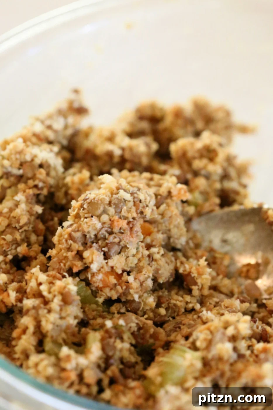 Adding sauces, seasonings, and breadcrumbs to the lentil quinoa mixture