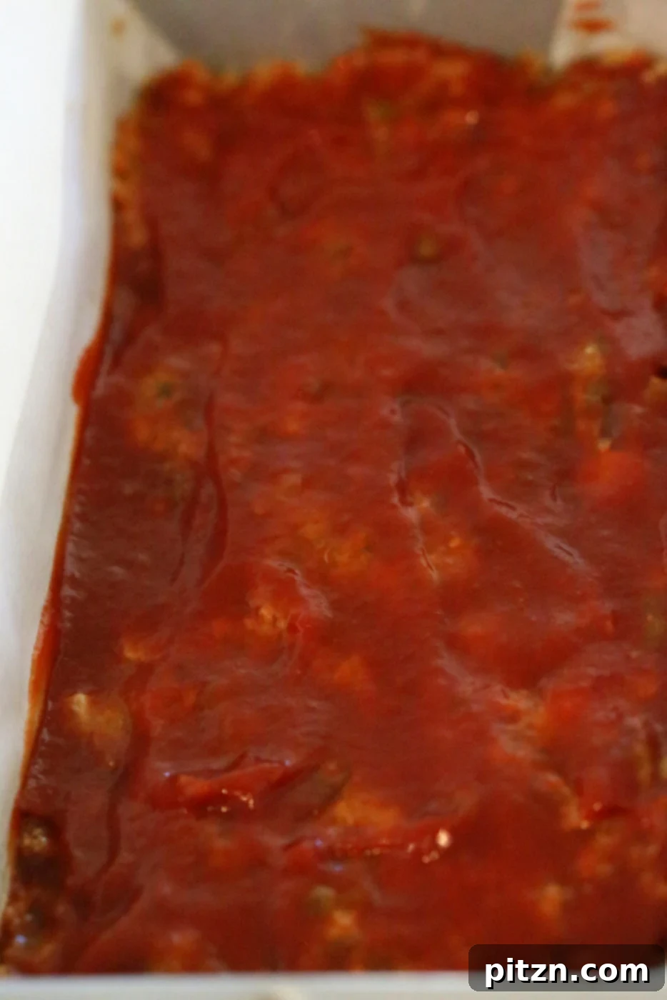 Brushing the glaze generously over the lentil quinoa loaf