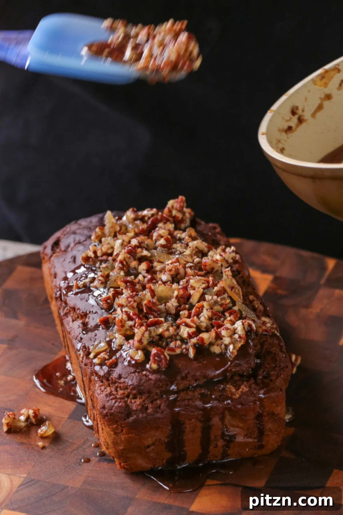 Luscious Triple Ginger Vegan Gingerbread Cake 3 Close-up shot of a hand drizzling the lustrous, sweet-and-spicy ginger glaze over the freshly baked vegan gingerbread cake, creating an inviting cascade of flavor.