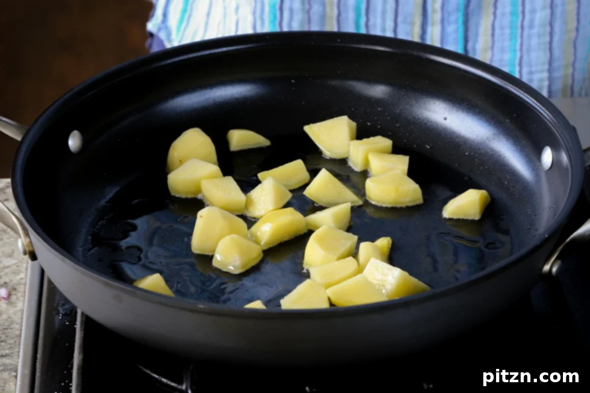 Robust Vindaloo Potato and Lentil Curry 10 potatoes in the pan before cooking