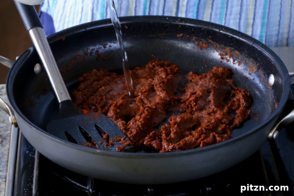 Robust Vindaloo Potato and Lentil Curry 16 adding water to the vindaloo sauce