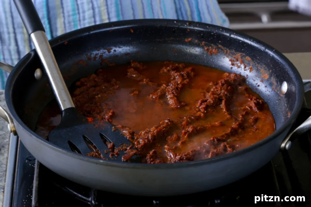 Robust Vindaloo Potato and Lentil Curry 17 adding remaining water to the vindaloo sauce