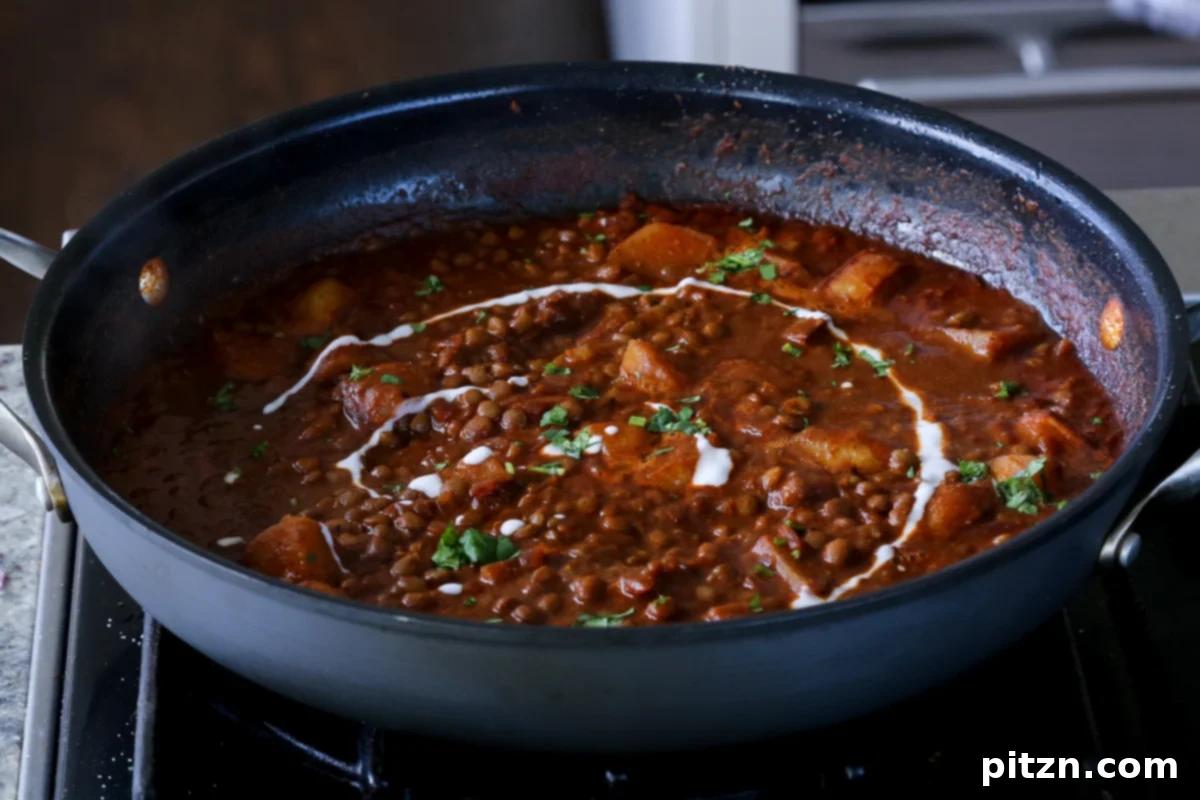 Robust Vindaloo Potato and Lentil Curry 20 lentils vindaloo in the pan after adding the toppings