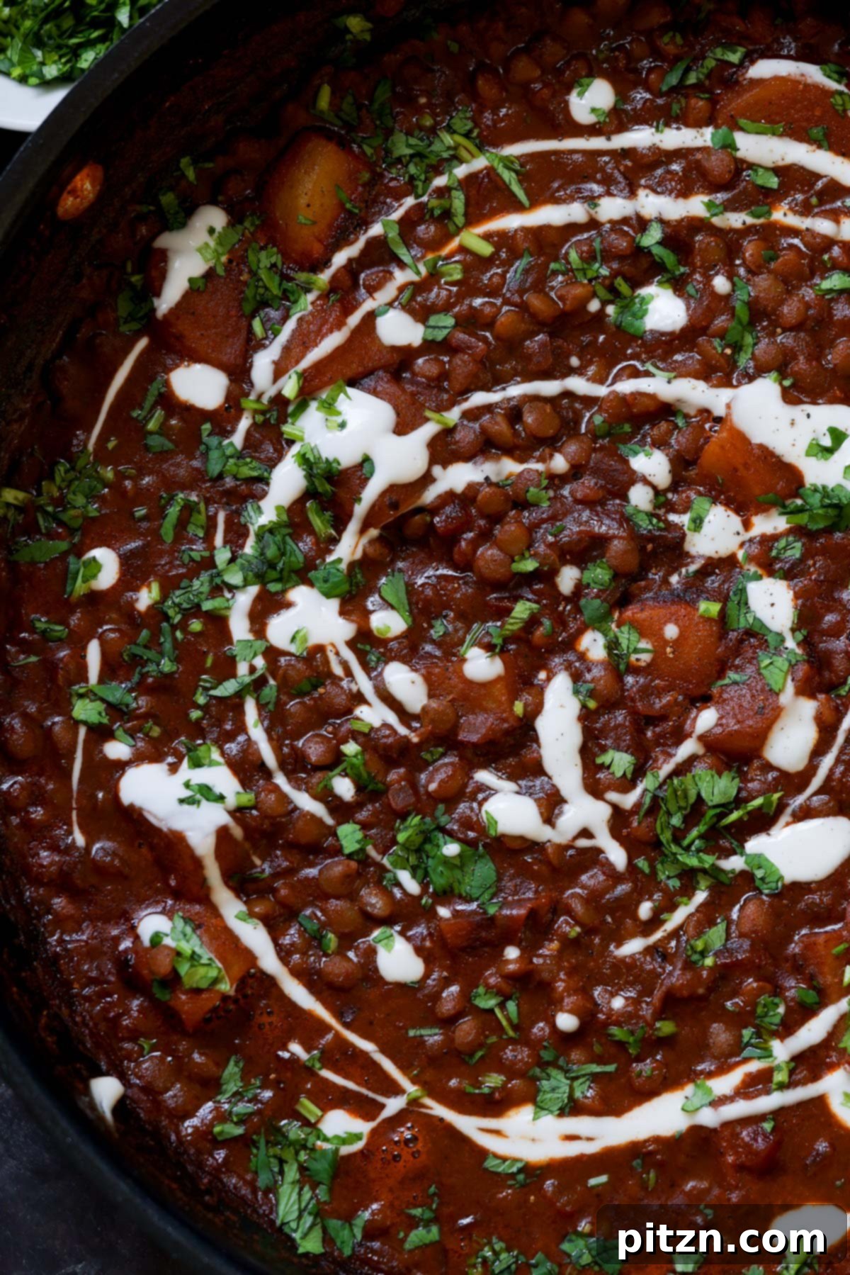 Robust Vindaloo Potato and Lentil Curry 5 close-up of lentils vindaloo in the pan after adding the toppings