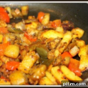 Indian Spiced Baingan Aloo Curry 2 A closeup of baingan aloo cooking in a pan