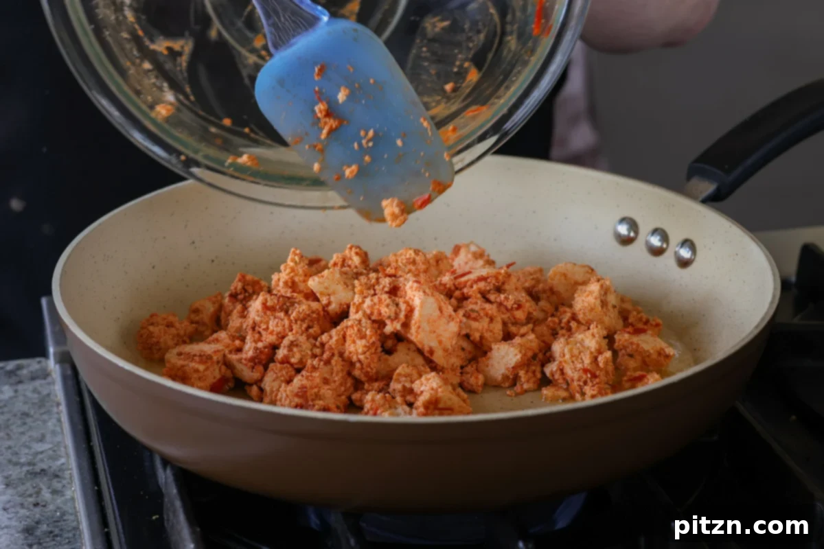 30-Minute Harissa Tofu Bowls for All Diets 12 adding the harissa tofu to the pan