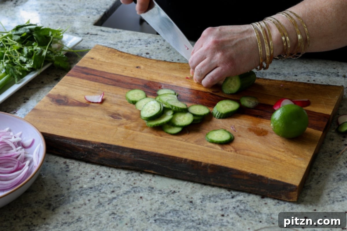 30-Minute Harissa Tofu Bowls for All Diets 19 slicing the cucumber