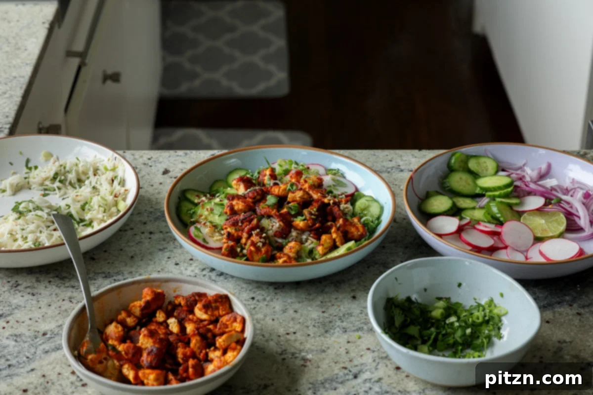 30-Minute Harissa Tofu Bowls for All Diets 22 harissa tofu bowl surrounded by all of the prepped ingredients