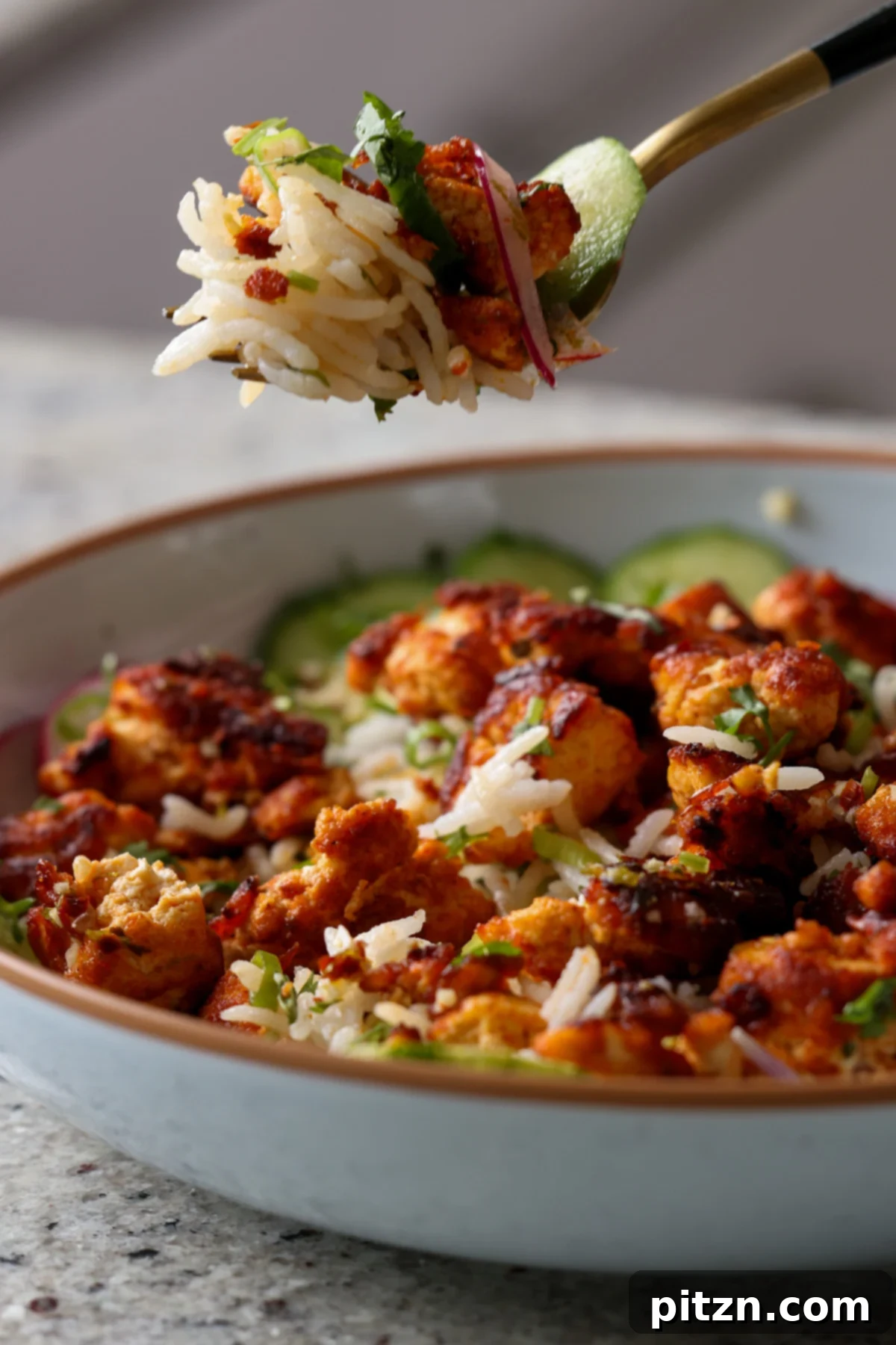 30-Minute Harissa Tofu Bowls for All Diets 4 fork taking a bite of harissa tofu and herbed rice