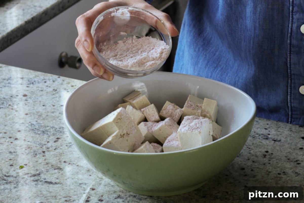 Flaky Indo Chinese Chilli Garlic Tofu Parcels 10 Adding cornstarch to the seasoned tofu cubes to create a crispy coating.