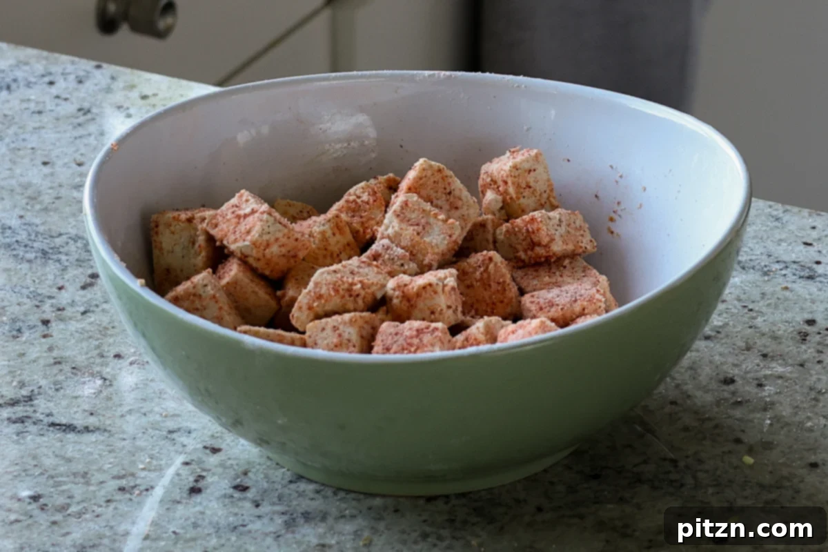 Flaky Indo Chinese Chilli Garlic Tofu Parcels 11 Tofu cubes fully coated in cornstarch and spices, ready for pan-frying.