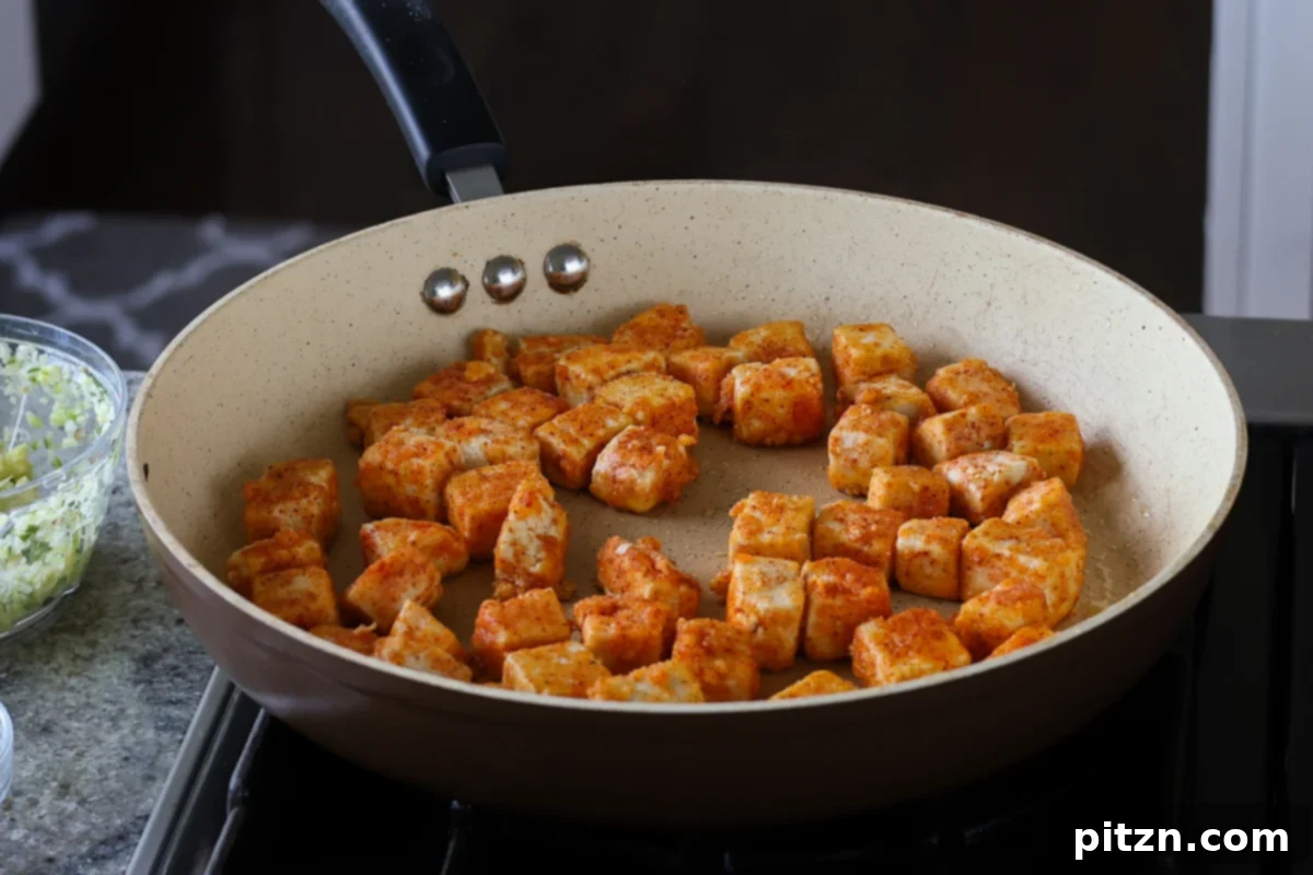 Flaky Indo Chinese Chilli Garlic Tofu Parcels 13 Crispy tofu cubes after being flipped in the pan, showcasing a golden-brown texture.