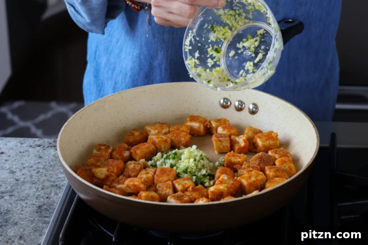 Flaky Indo Chinese Chilli Garlic Tofu Parcels 14 Finely chopped ginger, garlic, and green chili sautéing in oil in a pan, releasing their aromatic flavors.