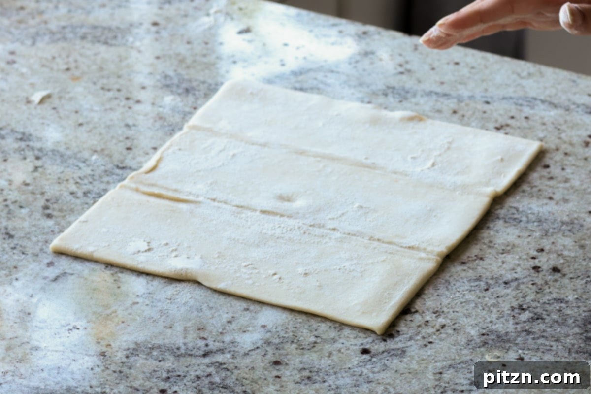 Flaky Indo Chinese Chilli Garlic Tofu Parcels 19 An unfolded sheet of puff pastry ready on a floured surface for rolling.