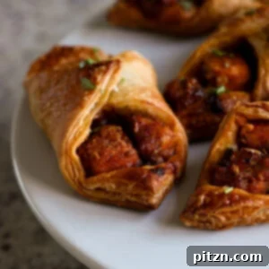 Close-up of golden brown chilli garlic tofu puff pastry parcels on a baking sheet, ready to be served.
