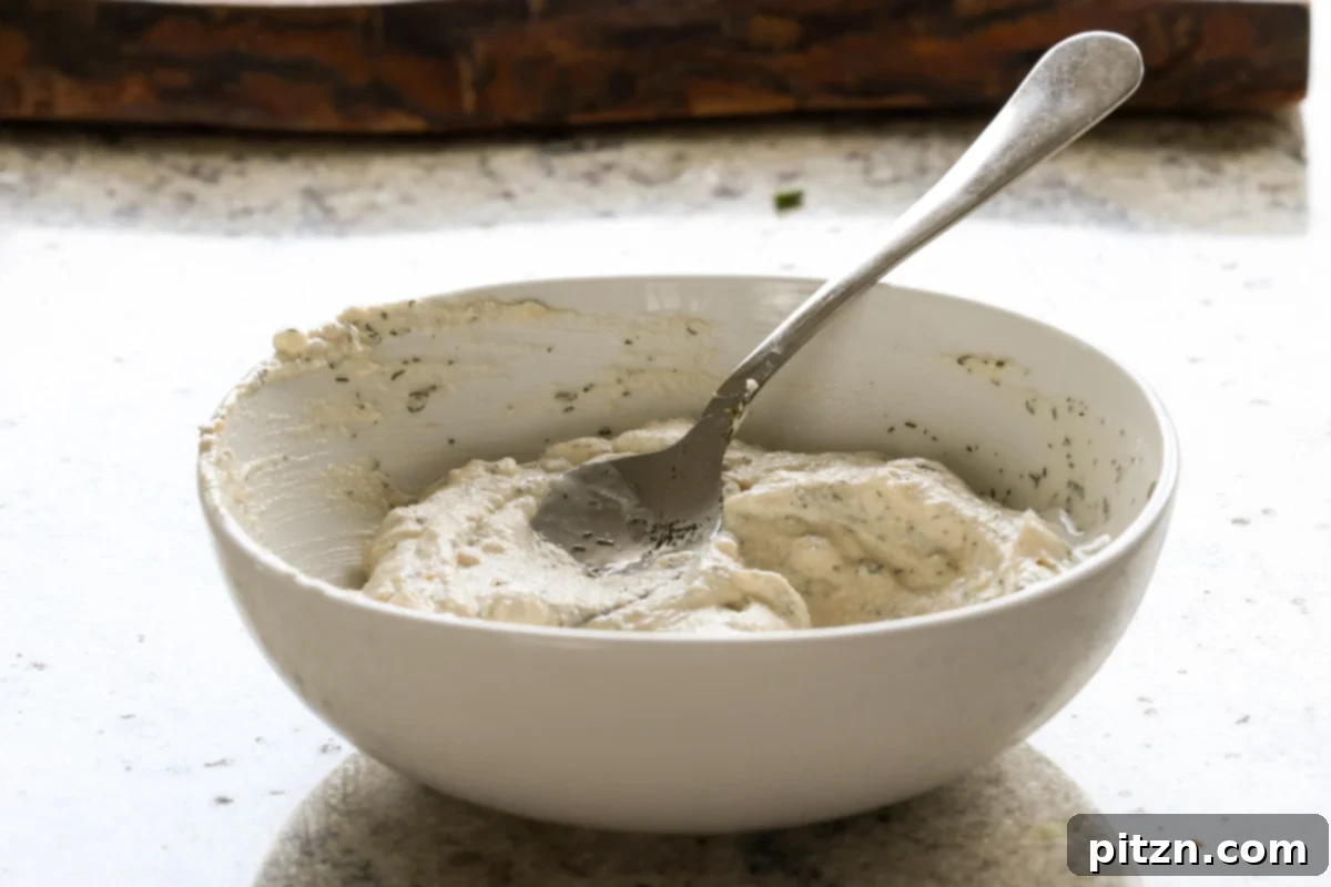 Vegan Jalapeño Popper Pinwheels 12 The jalapeño popper dip ingredients are perfectly mixed in the bowl, creating a smooth and creamy spread.