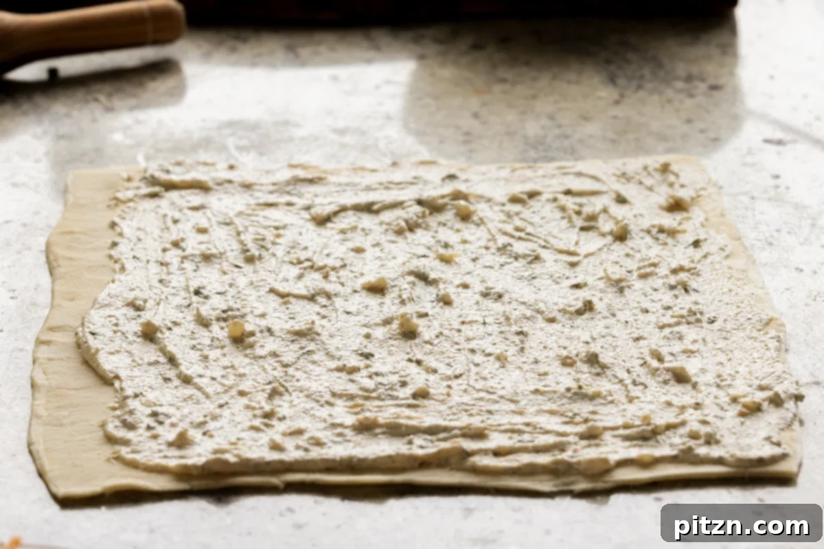 Vegan Jalapeño Popper Pinwheels 16 The creamy jalapeño popper dip is perfectly spread out onto the puff pastry, creating an even layer across the surface.