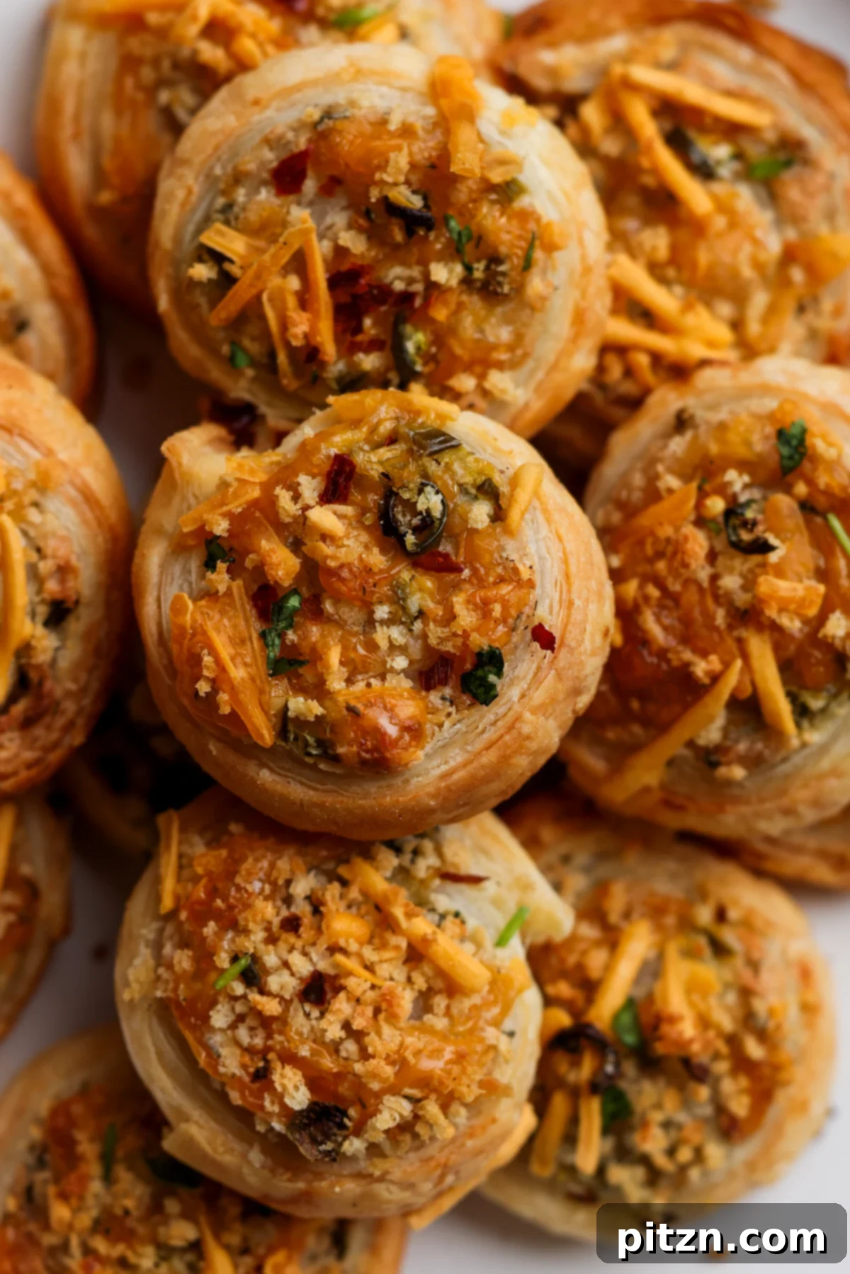 Vegan Jalapeño Popper Pinwheels 5 A wider shot of the jalapeño popper pinwheels elegantly presented on a serving platter, highlighting their perfect golden hue.