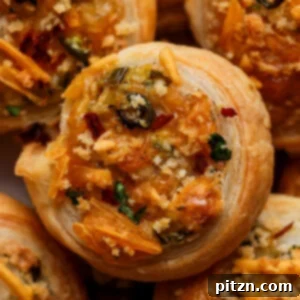 Vegan Jalapeño Popper Pinwheels 6 Close-up of golden-brown vegan jalapeño popper pinwheels arranged on a sophisticated serving platter, ready to be enjoyed.