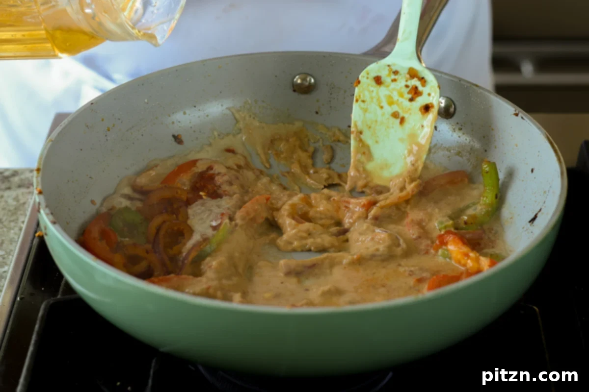 miso paste being stirred into the creamy tahini broth in the pan, dissolving into the liquid