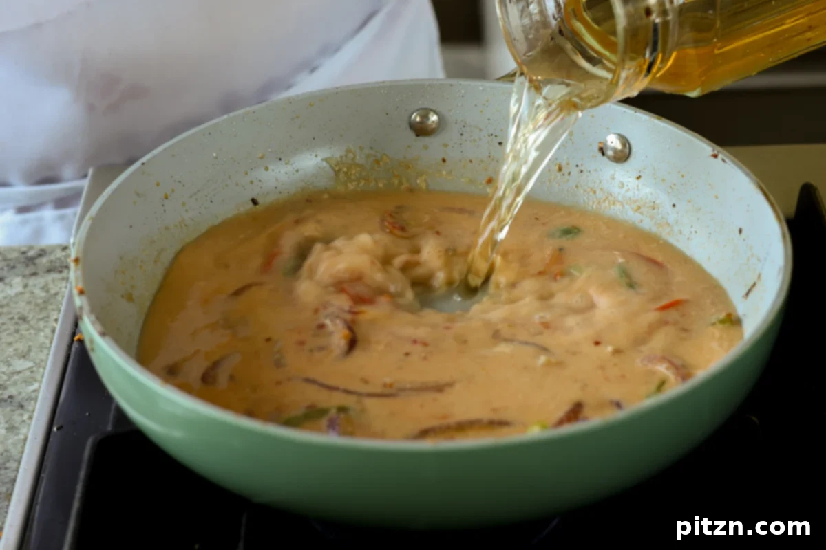 the remaining stock being poured into the tahini miso broth in the pan, increasing the liquid volume