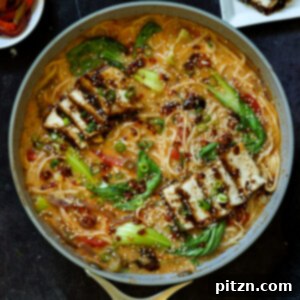 panful of creamy tahini ramen with teriyaki tofu on top