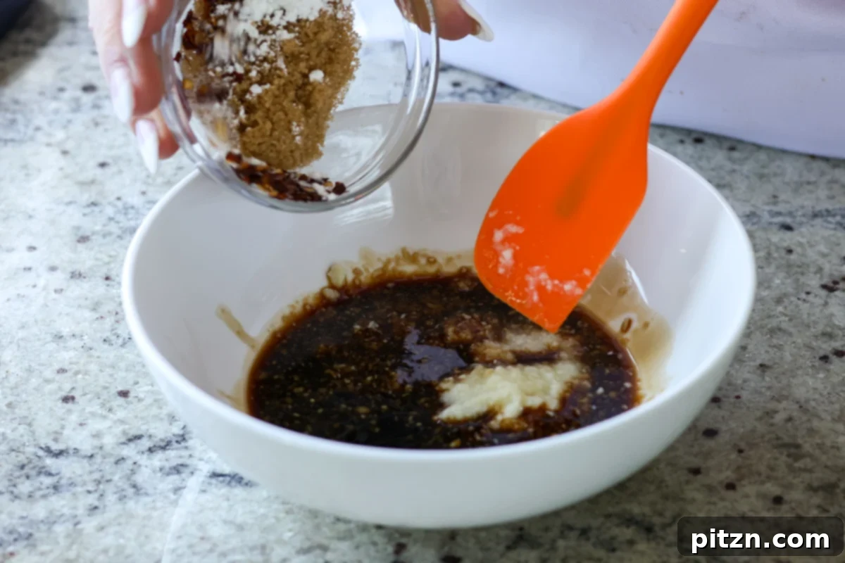 a bowl containing the whisked ingredients for the teriyaki sauce, illustrating the smooth consistency