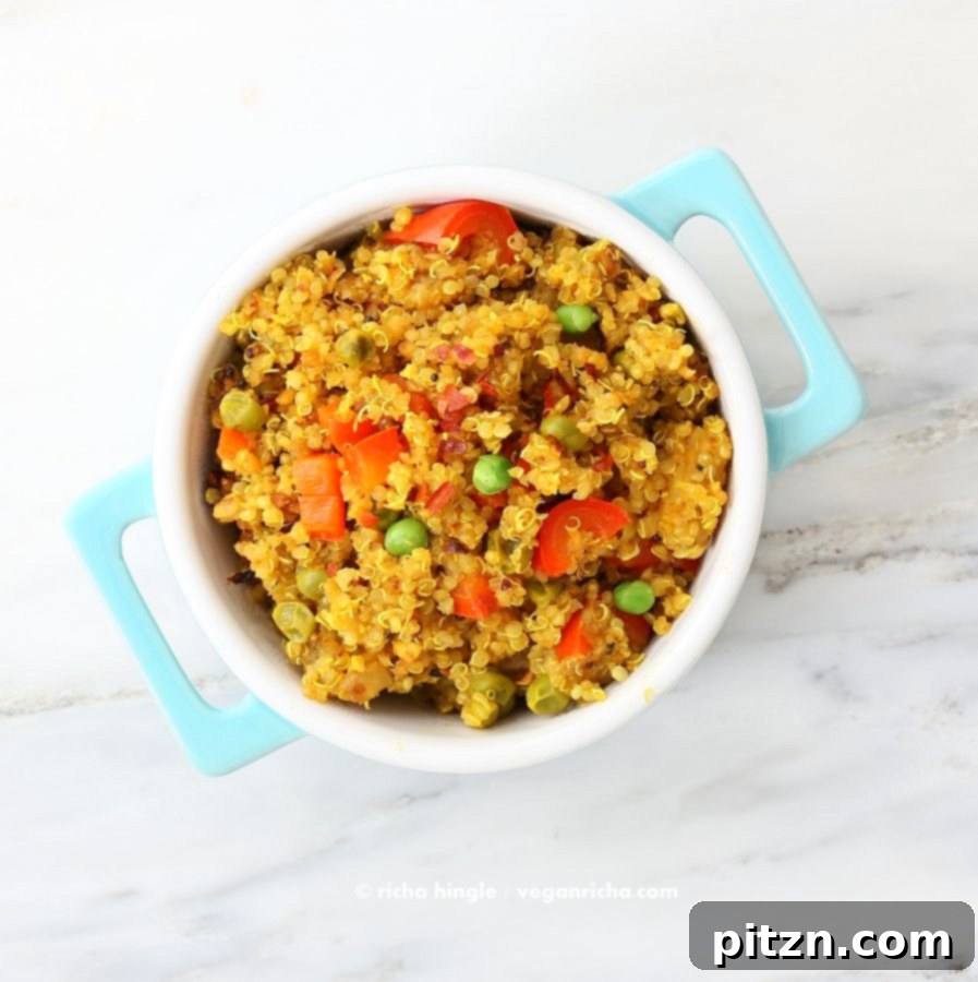 South Indian Harvest Quinoa with Tamarind and Pumpkin 3 Overhead view of South Indian Quinoa Salad in a blue polka dot dish, emphasizing its rich texture and colorful vegetables