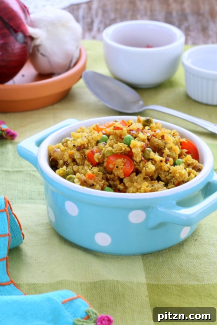 South Indian Harvest Quinoa with Tamarind and Pumpkin 4 Close-up of South Indian Quinoa Salad in a blue polka dot dish with a serving spoon, highlighting the grains and vibrant ingredients