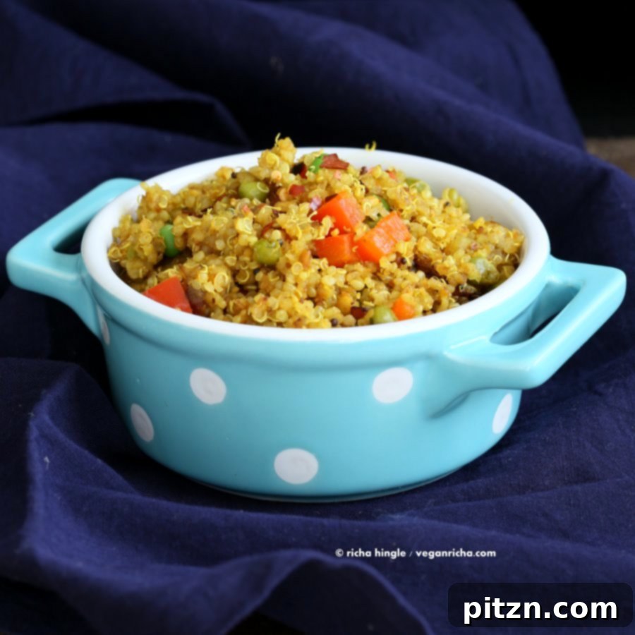 South Indian Harvest Quinoa with Tamarind and Pumpkin 5 South Indian Quinoa Salad in a blue polka dot dish placed on a blue striped towel, perfect for a cozy, healthy meal