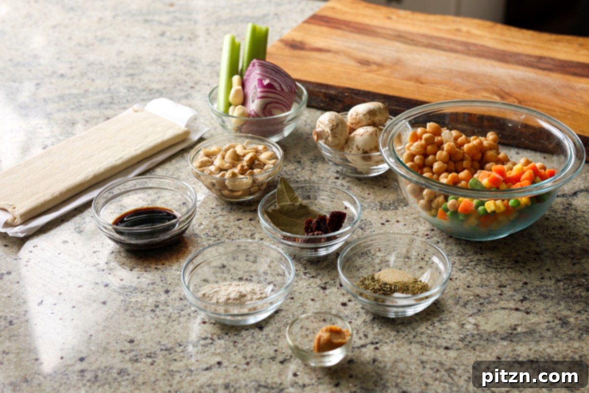 Assortment of fresh ingredients for mini pot pies laid out on a kitchen counter.