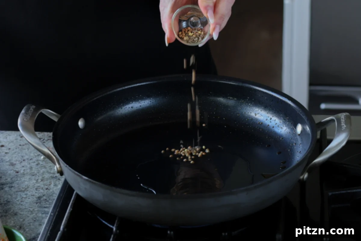 adding whole spices to the pan